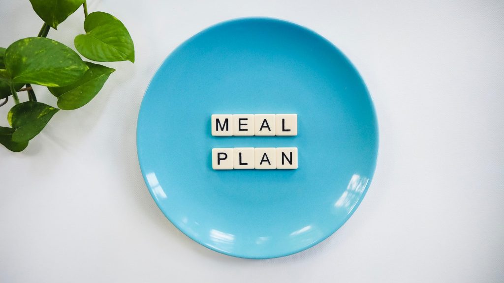 meal plan written with scrabble letters on a blue plate