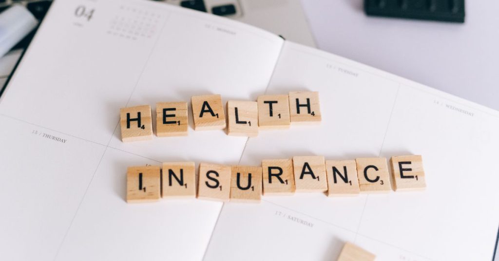 health insurance spelled out is scrabble tiles